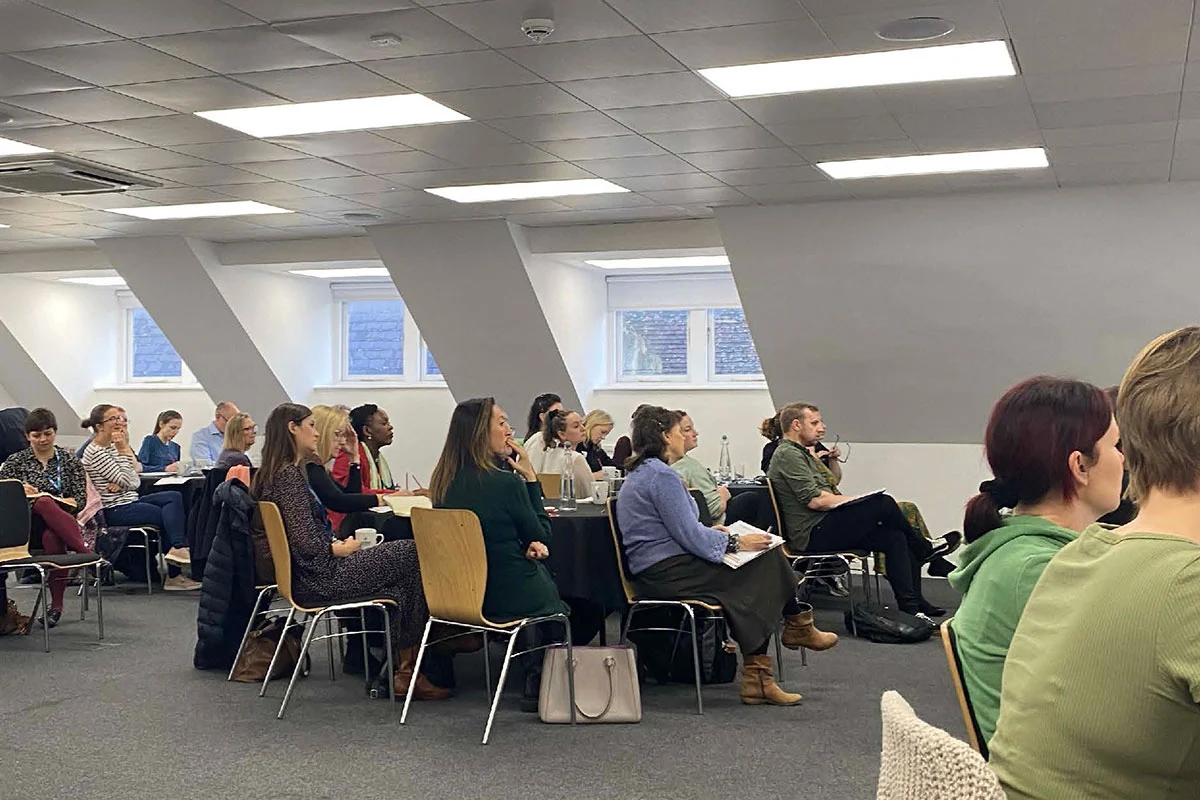 Group of people seated listening to talk